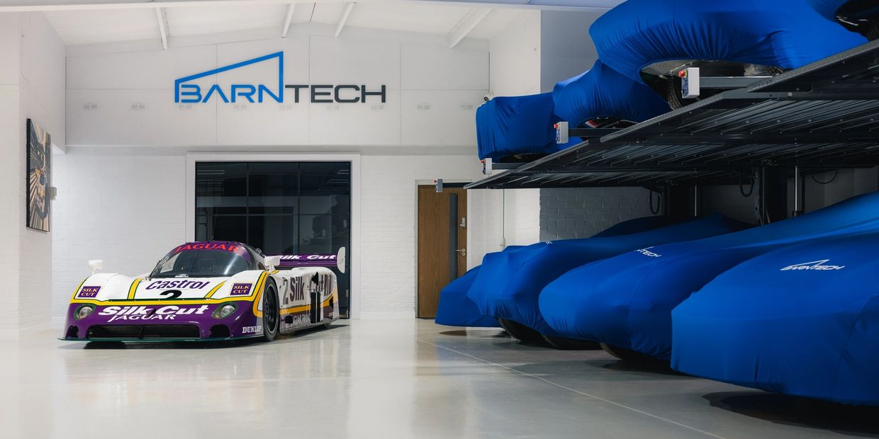 BarnTech storage facility with the Silk Cut Jaguar race car and covered vehicles on storage lifts